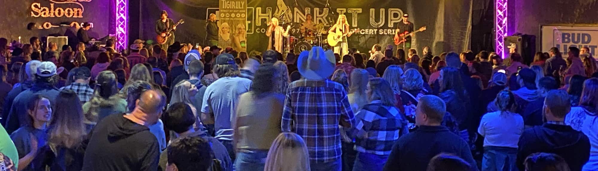 country concert with fans wearing cowboy hats Richmond