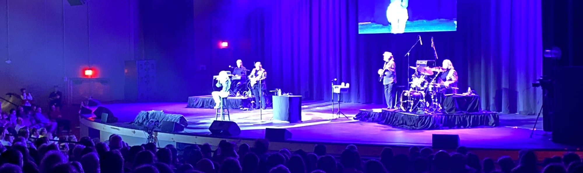 signer on stage in chair washed out by the lights Richmond